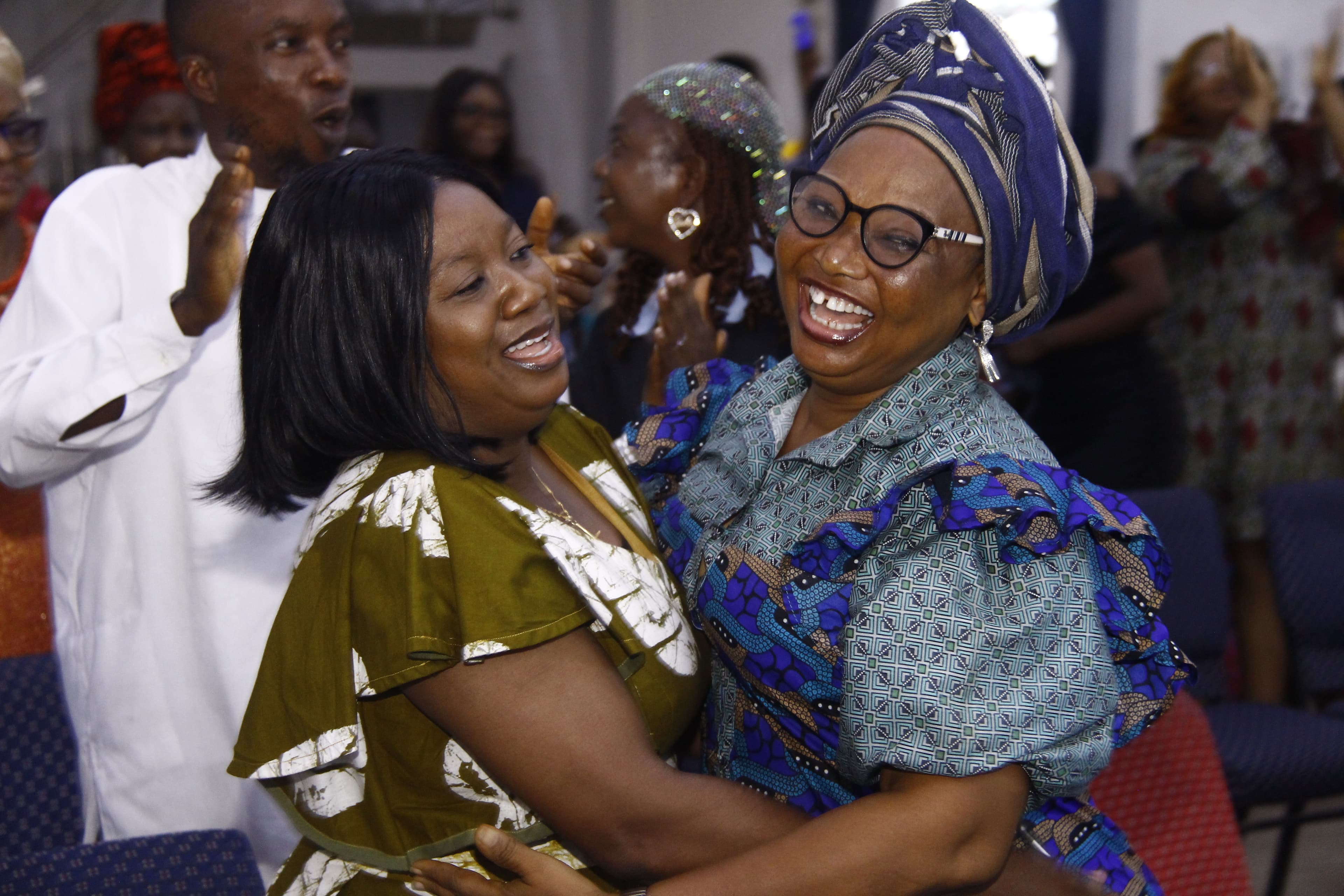 Two women embracing and laughing with pure joy