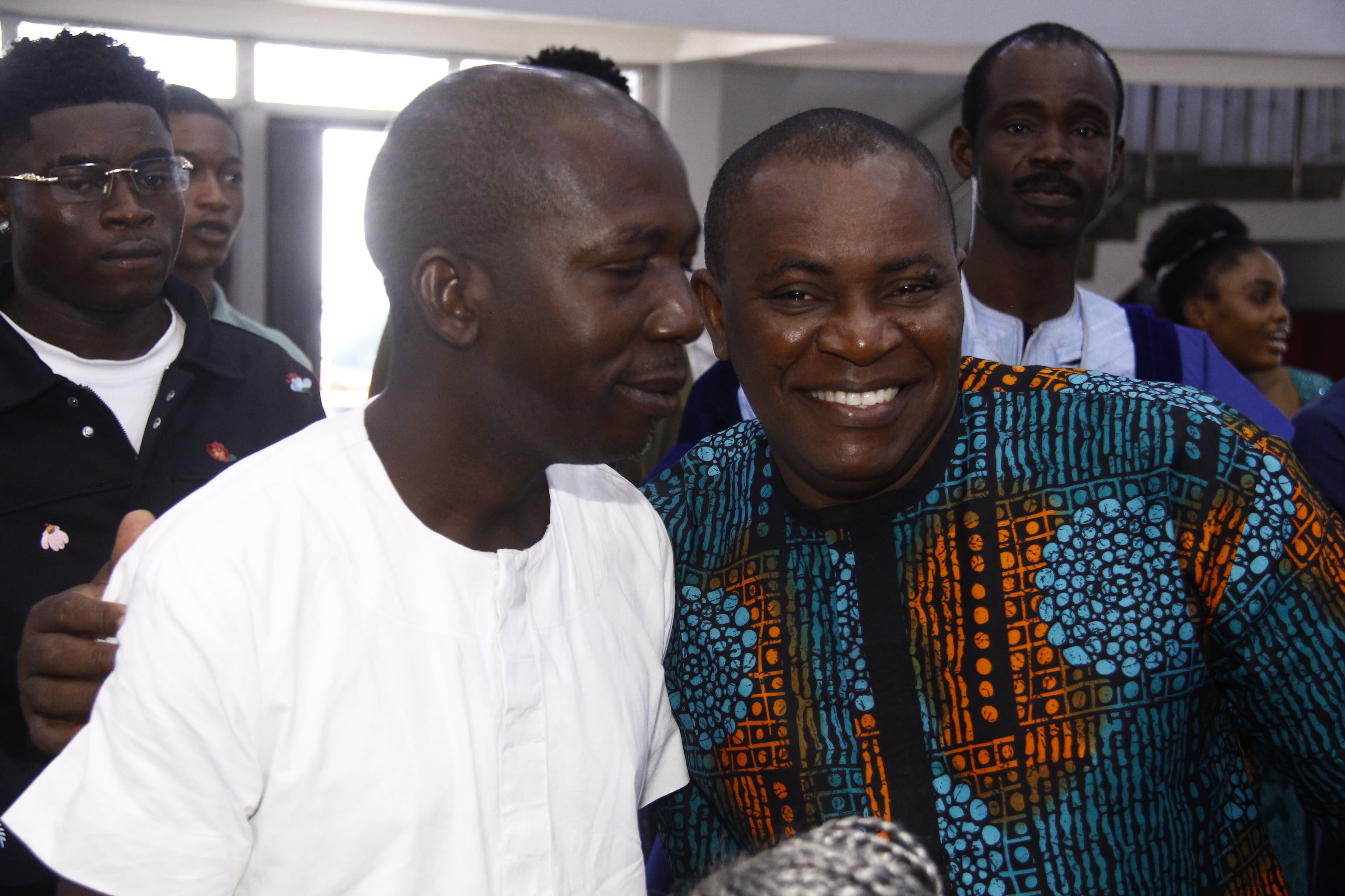 Two men in warm brotherhood embrace