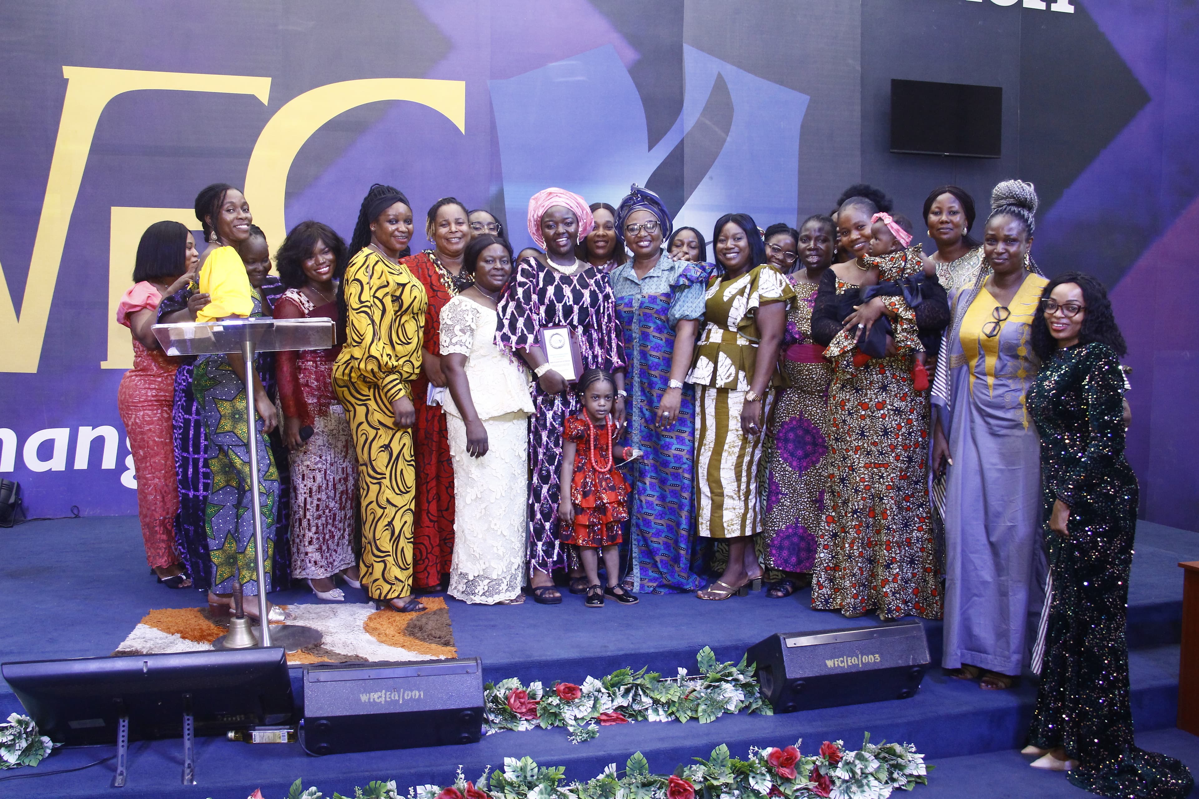 Women gathered on stage in vibrant African prints