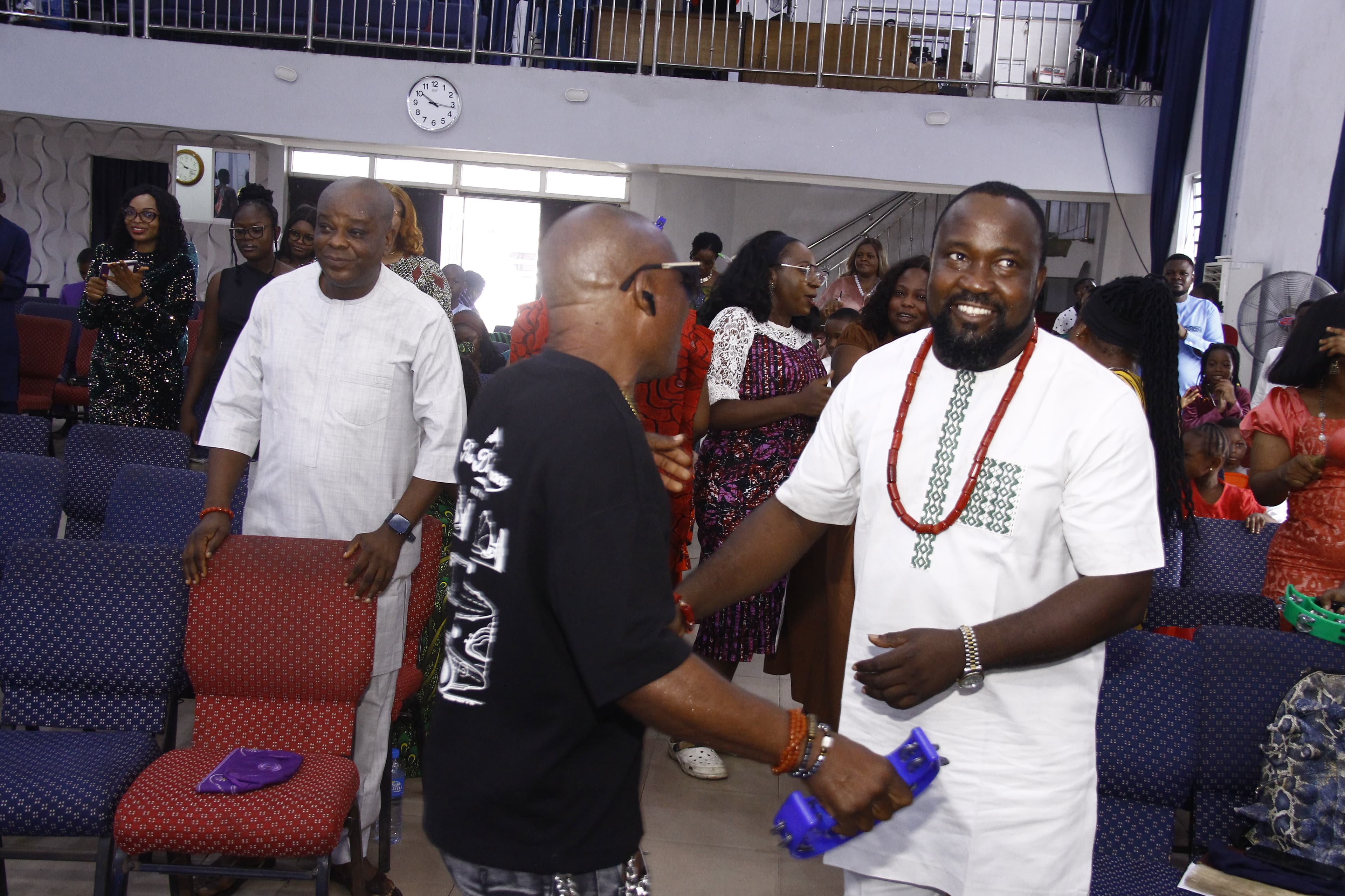 Men greeting each other with warm handshakes and smiles