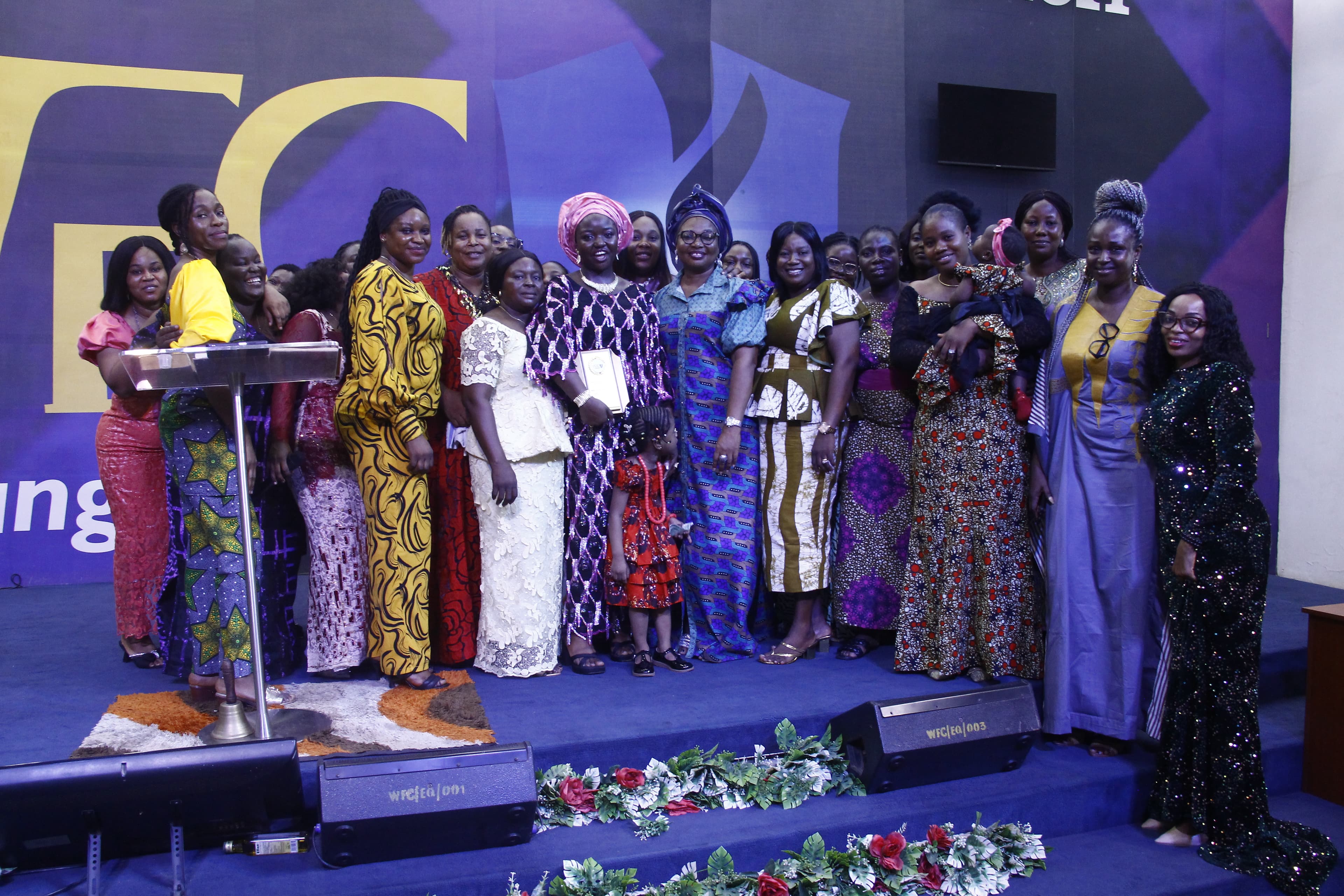 Large women's group photo in diverse colorful outfits