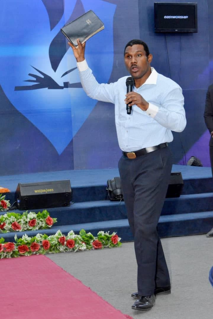 Pastor at the pulpit with Bible in hand, preaching with passion