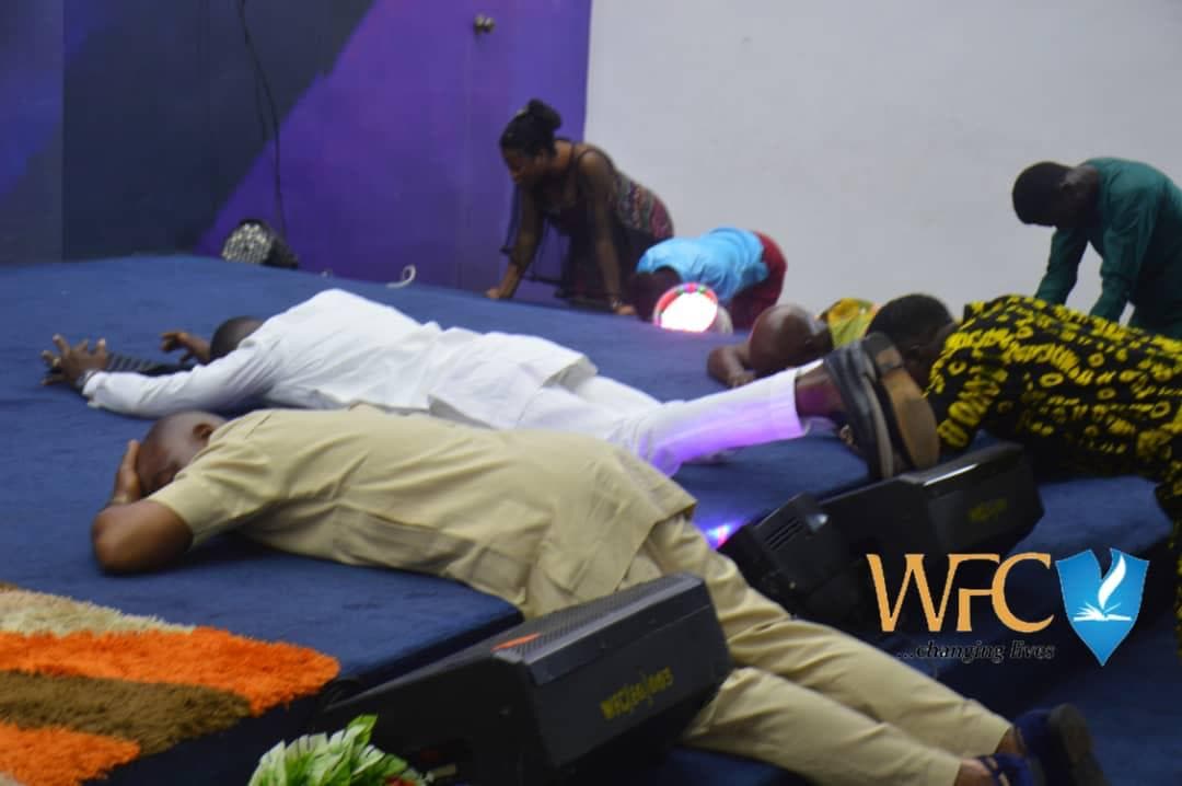 People prostrate at altar during intense spiritual moment