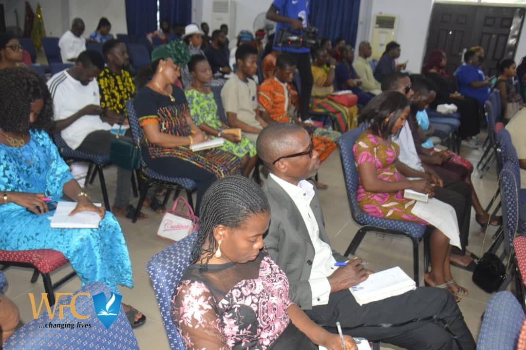 Congregation seated taking notes during teaching