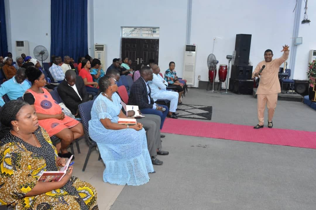 Woman leading worship in multicolor floral dress
