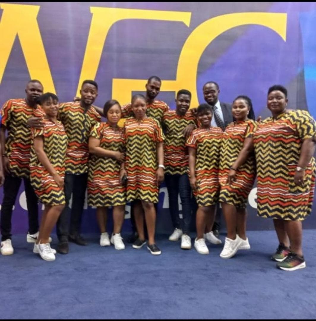 Women in vivid African prints standing near the stage